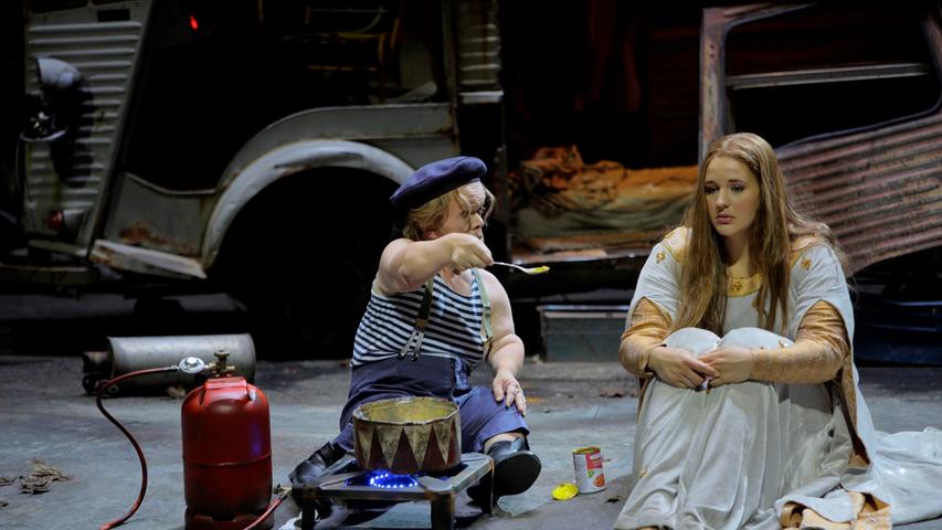 Little man gives something to eat to a sick young woman